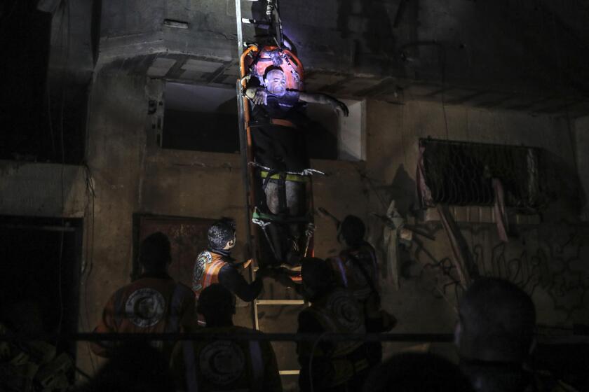 Palestinian civil defence members evacuate survivors of the Israeli bombardment on a residential building of Abu Alenan family in Rafah, southern Gaza Strip, early Saturday, May 4, 2024. (AP Photo/Ismael Abu Dayyah)