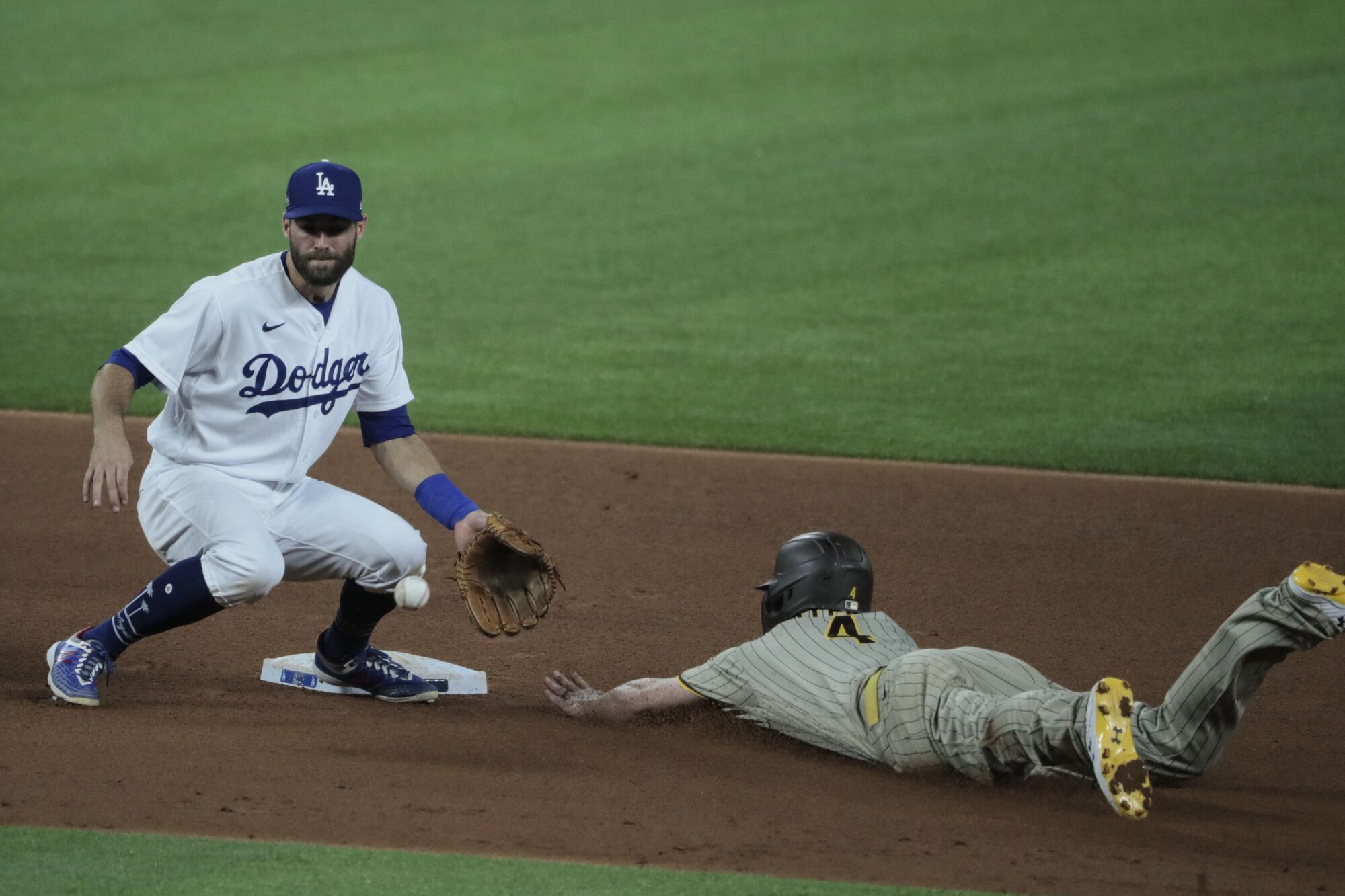 San Diego's Will Smith steals second in front of Dodgers second baseman Chris Taylor.