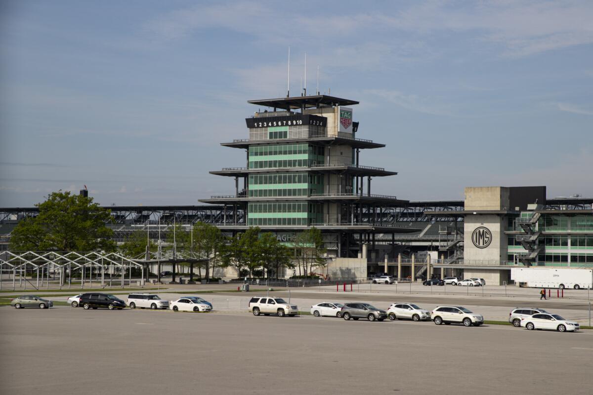 Vehicles line up at Indianapolis Motor Speedway on May 23, 2020, for a mobile food distribution event.
