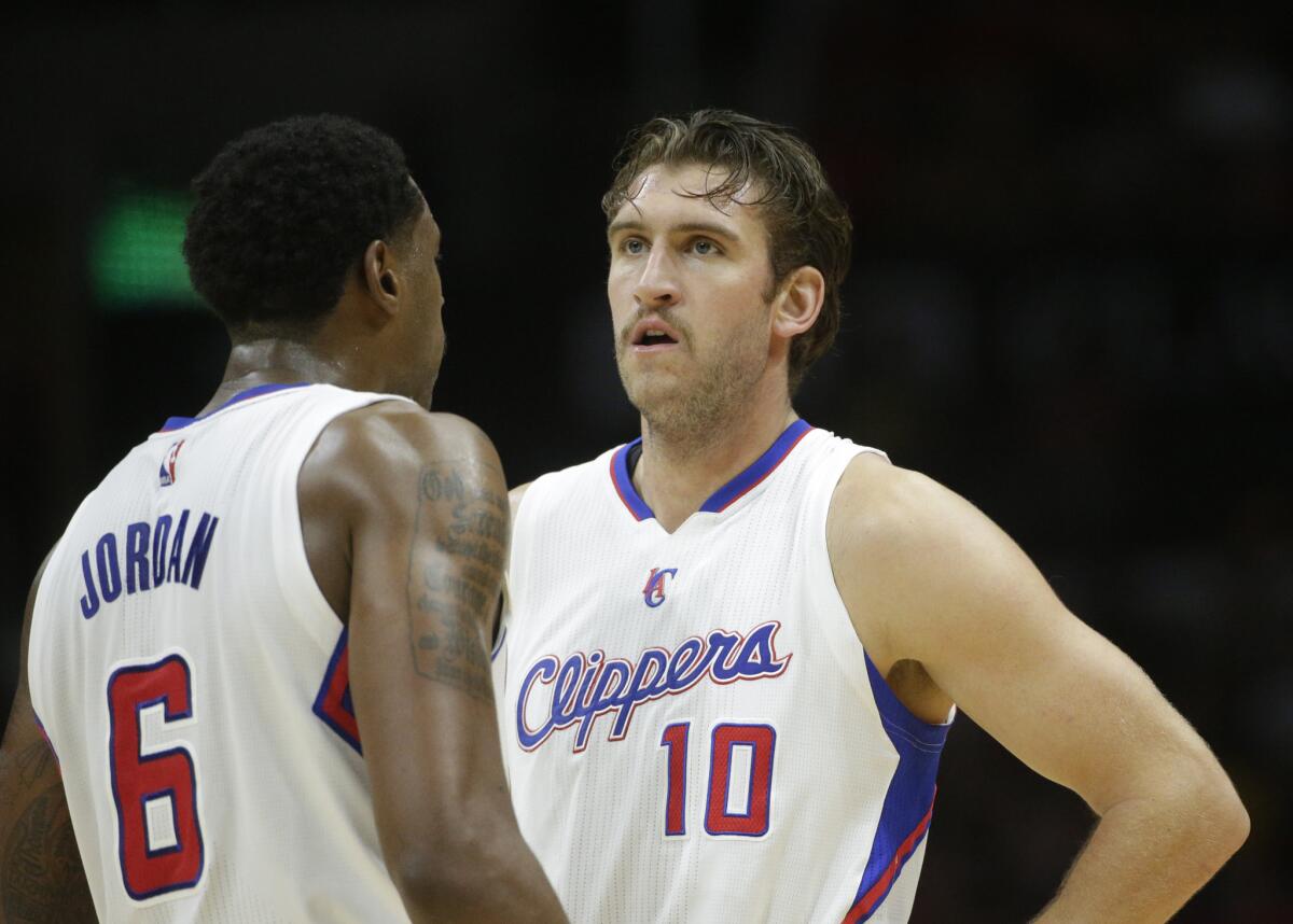 Spencer Hawes, right, talks to Clippers teammate DeAndre Jordan during a game against Portland.