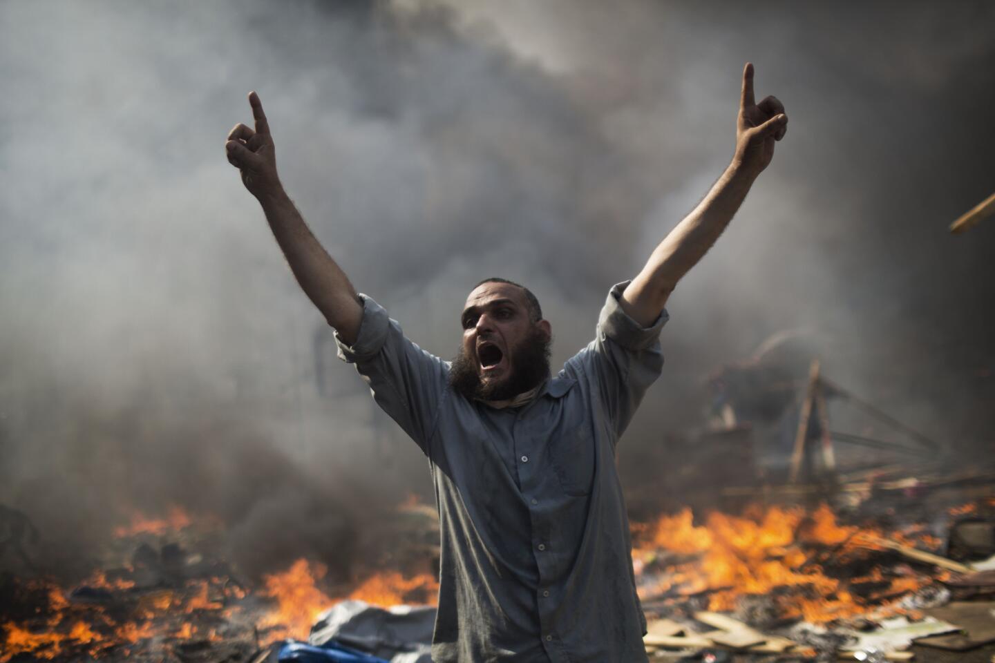 Aug. 14: Morsi supporter amid burning wreckage