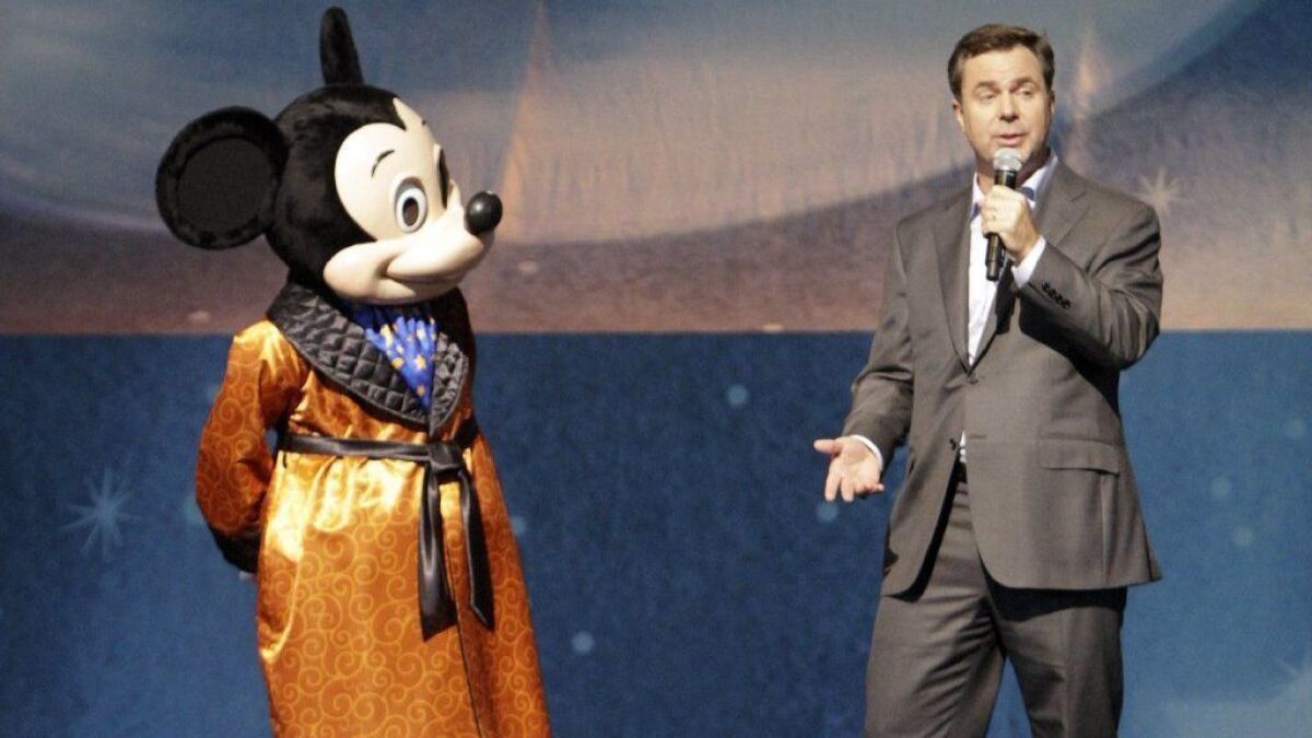 Michael Colglazier, who oversees the Disneyland Resort in Anaheim, at an event with Mickey Mouse. He will manage the company's Asia Pacific operations, starting March 5.