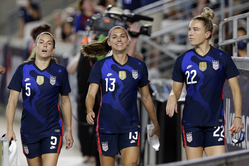 United States defender Kelley O'Hara (5), forward Alex Morgan (13) and midfielder Kristie Mewis (22) walk onto the field