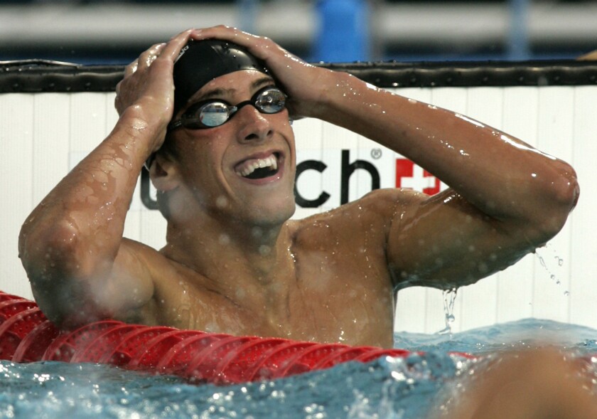 FILE - In this Aug. 14, 2004, file photo, Michael Phelps, of the United States, reacts after winning the 400-meter individual medley at the Olympic Aquatic Centre during the Olympic Games in Athens. For the first time since 1996, the U.S. Olympic swimming trials are being held without the sport's biggest star, the guy who won a staggering 23 gold medals and 28 medals overall at the Olympics. (AP Photo/Mark Baker, File)