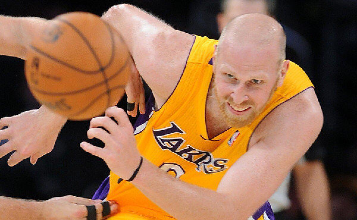Lakers center Chris Kaman chases after a loose ball during a game against the New Orleans Pelicans on Nov. 12. Kaman is unhappy with the amount of playing time he's been seeing under Lakers Coach Mike D'Antoni.