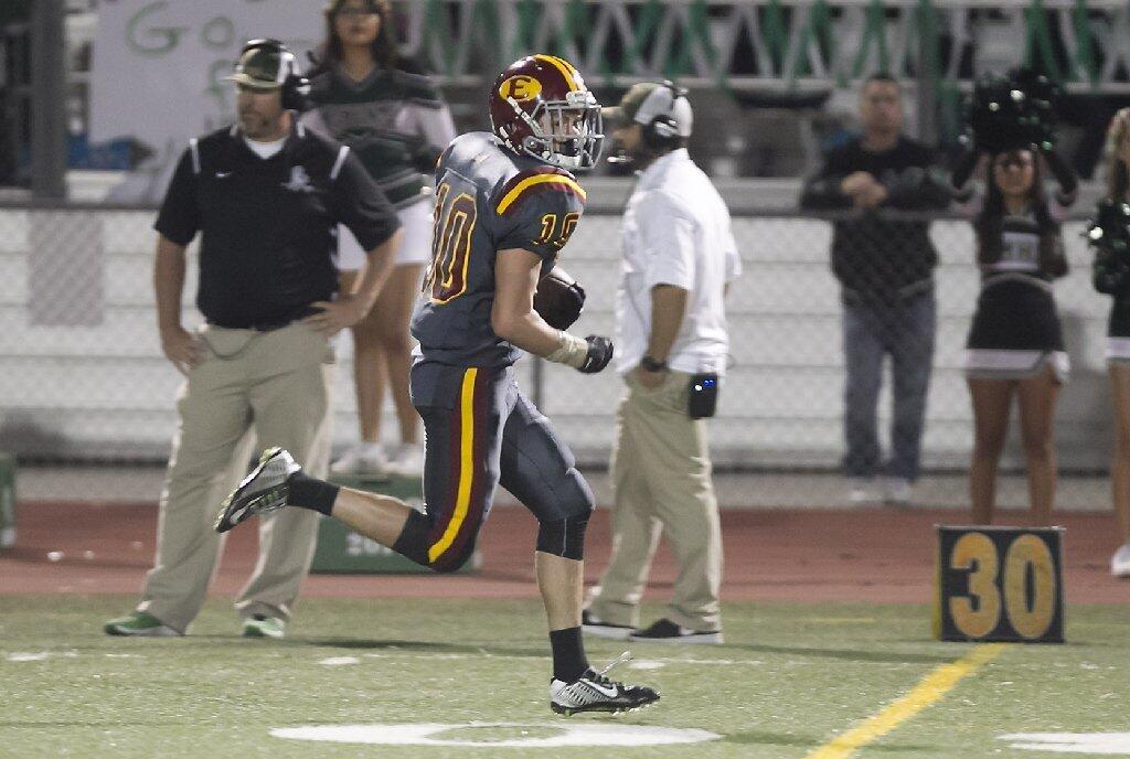 Estancia High's Tyler Ross runs away from Costa Mesa's defense for a touchdown during the Battle for the Bell.