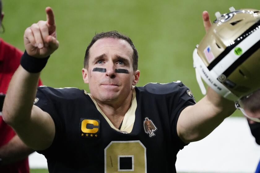 New Orleans Saints quarterback Drew Brees gestures to his family and fans after an NFL divisional round.