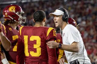 LOS ANGELES, CA - OCTOBER 21, 2023: USC Trojans head coach Lincoln Riley talks with quarterback.