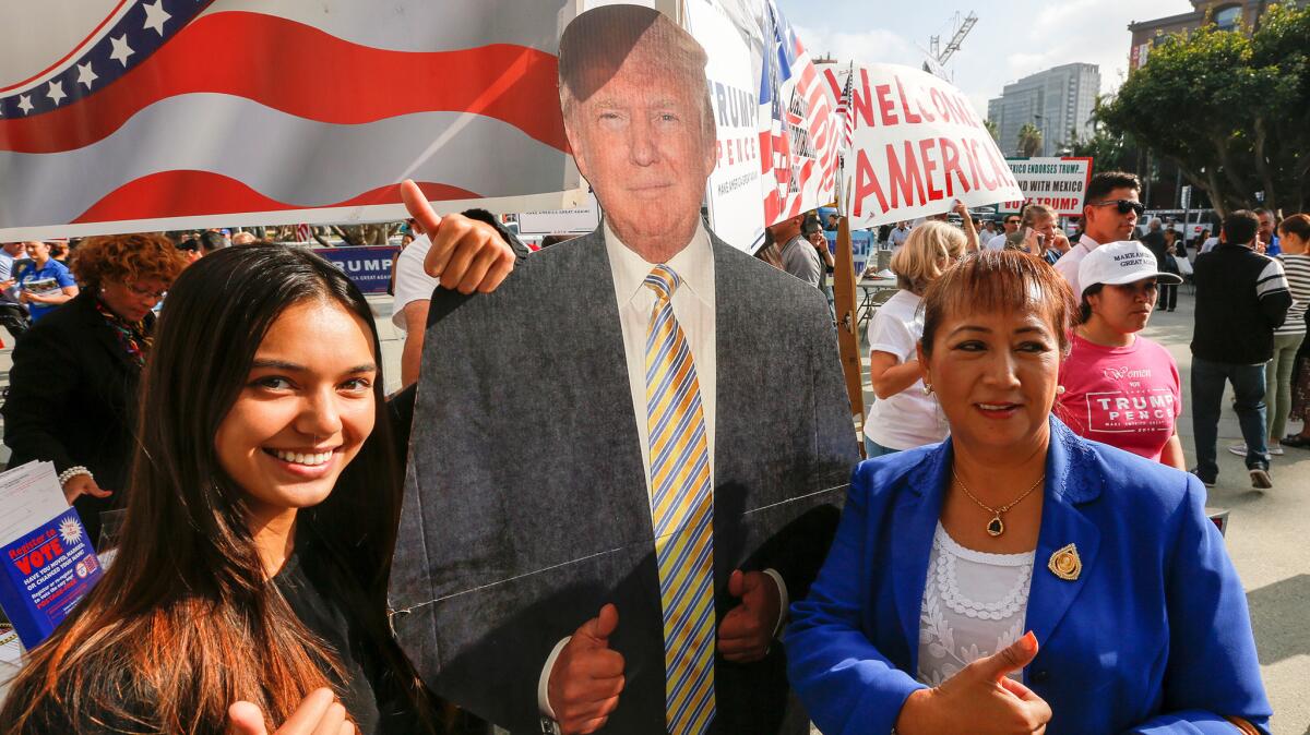 Crystal Siri and her mother, Maria Siri of Laos, pose with a Donald Trump cutout after being sworn-in.