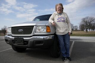 Carol Rice stands with her recently-purchased 2003 Ford Ranger Wednesday, March 15, 2023, in Shawnee, Kan. Rice's timing to buy the truck was ideal, taking advantage of a recent dip in used car prices which now appear to be heading back up. (AP Photo/Charlie Riedel)
