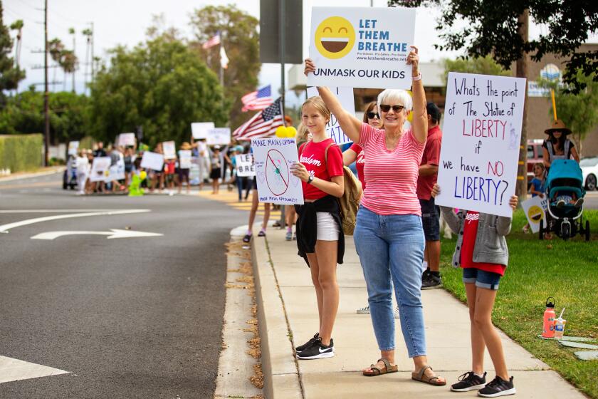 REDONDO BEACH, CA - JULY 27: Let Them Breathe, an anti-mask group, gather to protest at the Redondo Beach Unified School District building on Tuesday, July 27, 2021 in Redondo Beach, CA.(Jason Armond / Los Angeles Times)