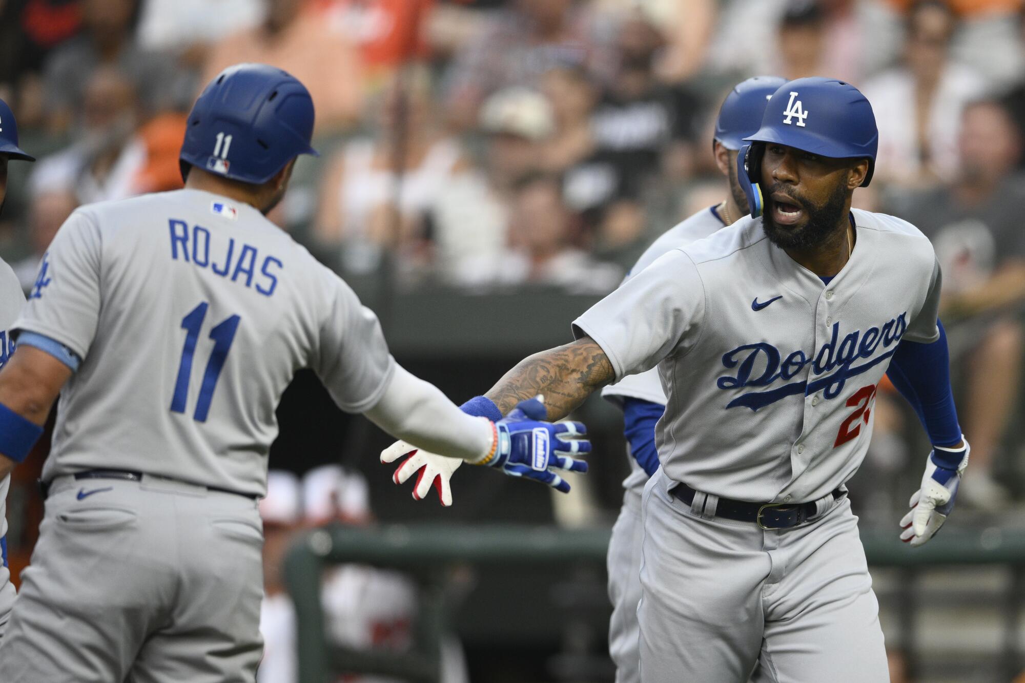 Dodgers' Jason Heyward, right, celebrates his home run with Miguel Rojas against the Baltimore Orioles on July 18, 2023.