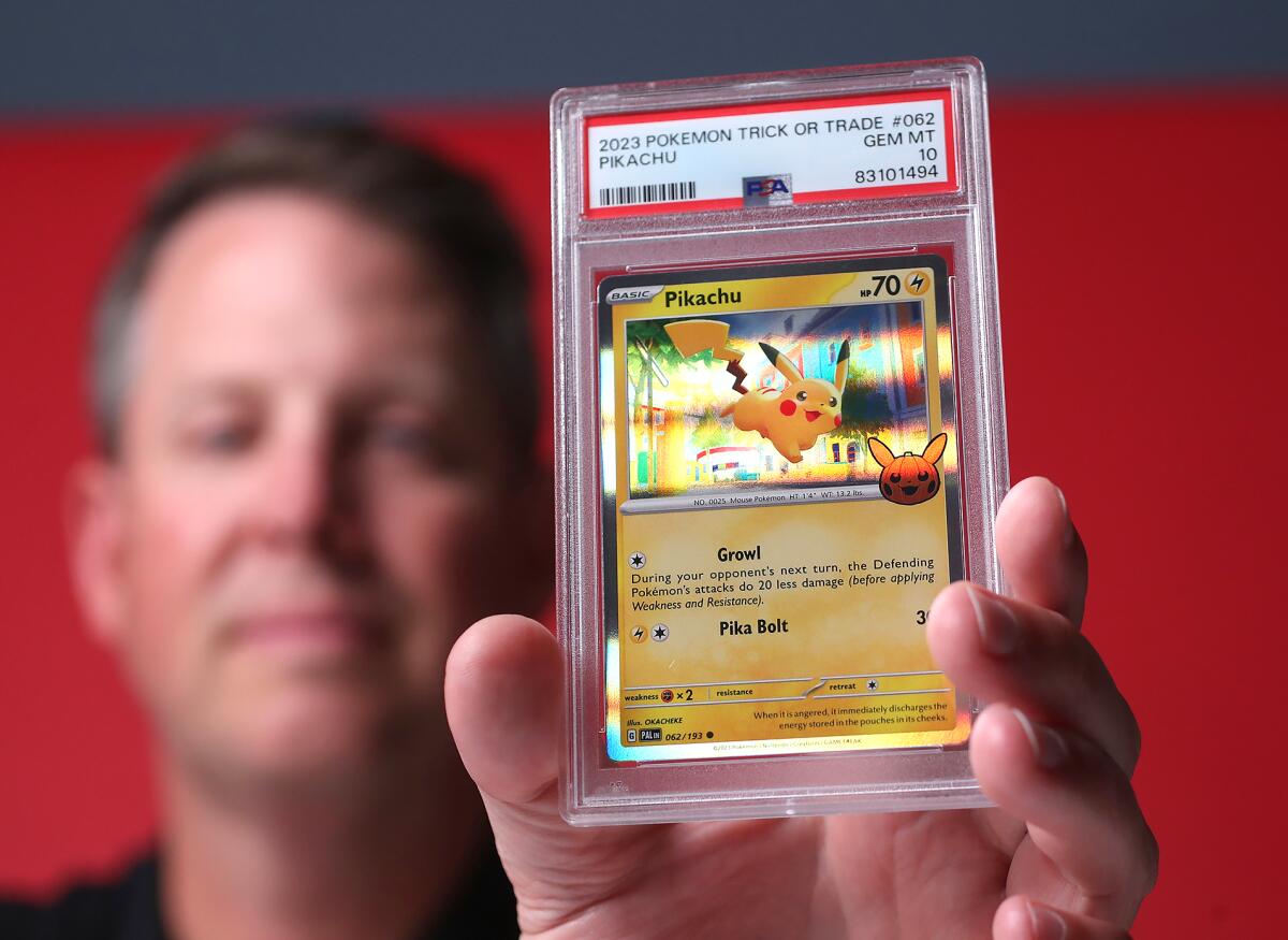 Ryan Hoge holds the very collectible grade 10, Pikachu trading card.