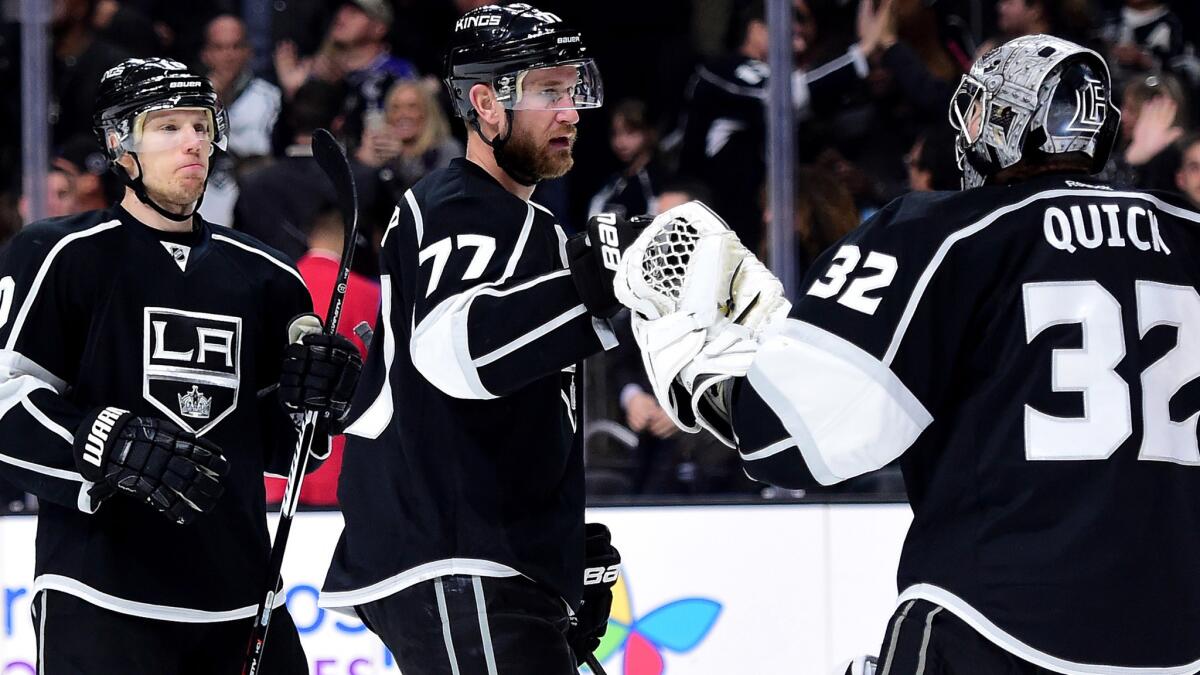 Kings center Jeff Carter (77) celebrates with goalie Jonathan Quick and defenseman Christian Ehrhoff after a 2-1 win over Toronto on Thursday.