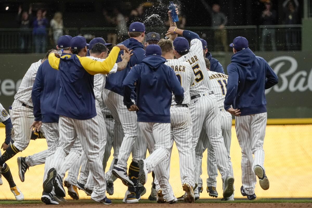 Milwaukee Brewers players celebrate after Travis Shaw hit a walk-off single in the 11th inning.