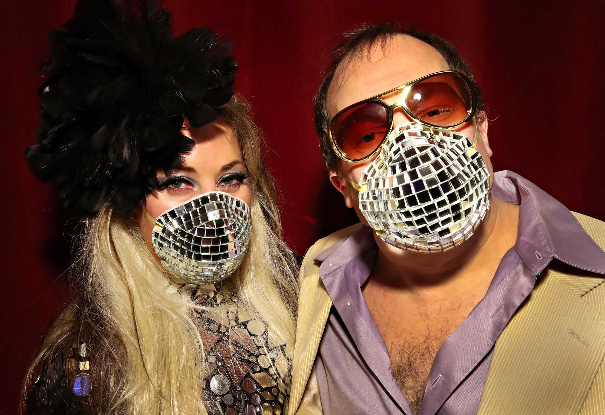 UNITED STATES: Allison Eden and Gary Goldenstein wear disco-ball-inspired masks during the opening of the "Studio 54: Night Magic" exhibit at the Brooklyn Museum in New York.