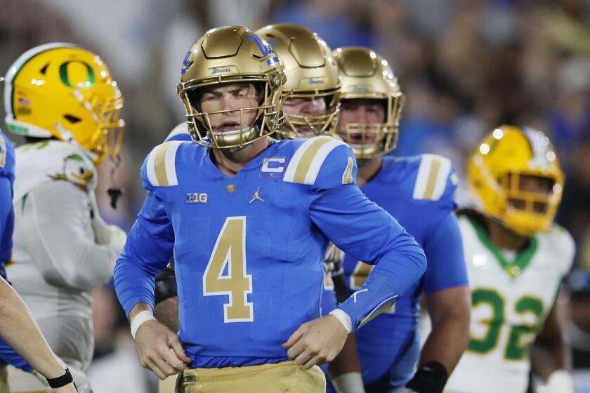 Pasadena, CA - September 28: UCLA quarterback Ethan Garbers, #4, gets up and recovers after being sacked by Oregon defense in the second quarter at the Rose Bowl in Pasadena Saturday, Sept. 28, 2024. (Allen J. Schaben / Los Angeles Times)