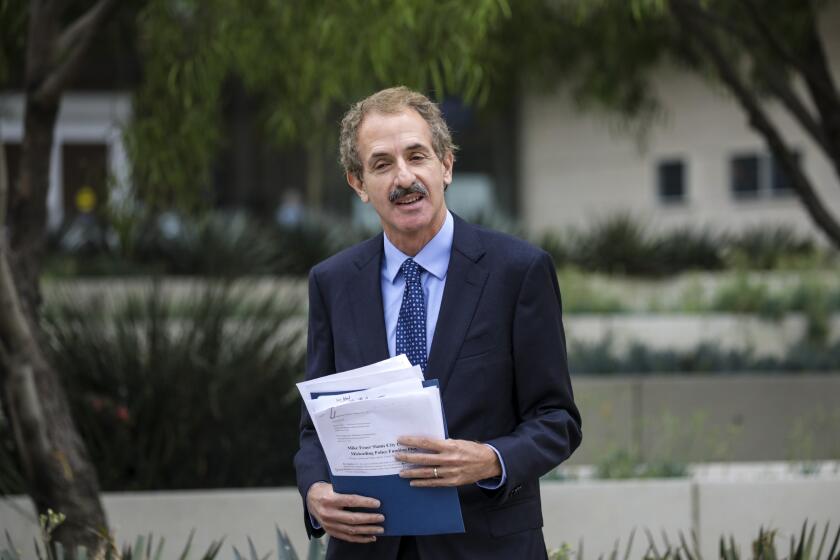 Los Angeles, CA - August 31: Los Angeles City Attorney Mike Feuer, who is running for mayor in 2022, in response to a Los Angeles Times story on police overtime, goes over his notes prior to a news conference in front of LAPD Headquarters on Tuesday, Aug. 31, 2021 in Los Angeles, CA. (Irfan Khan / Los Angeles Times)