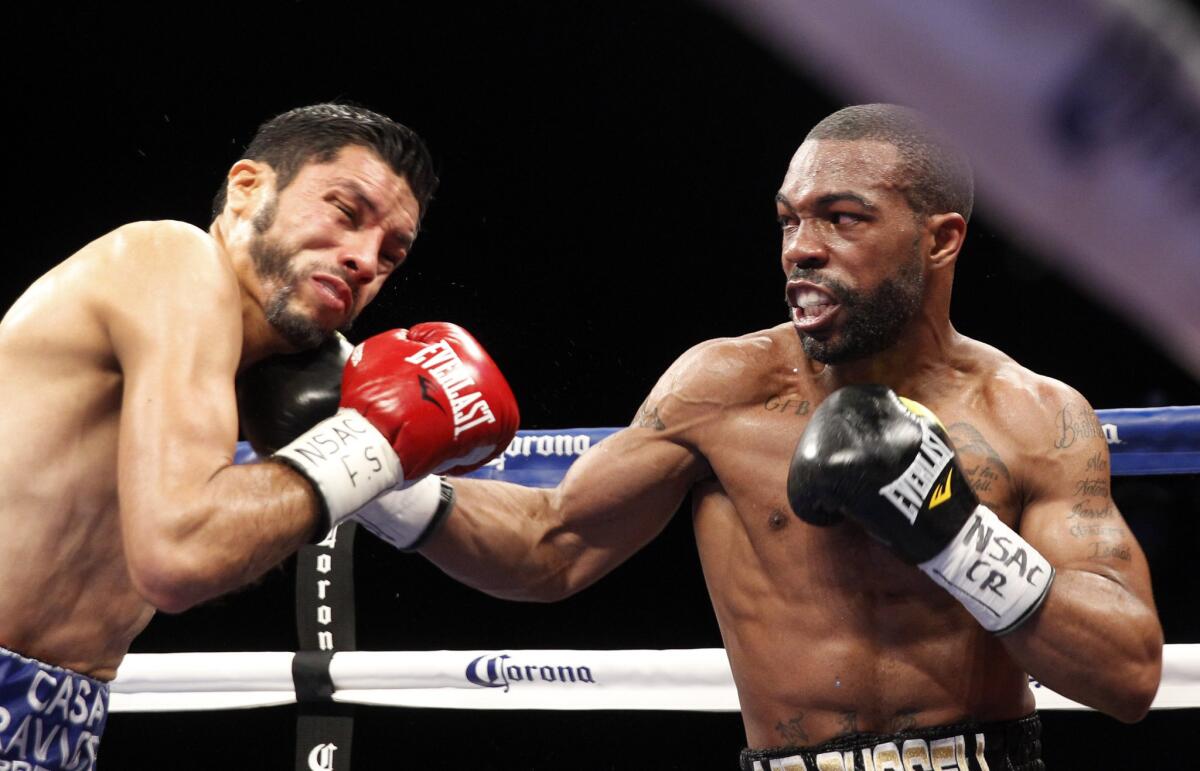 Gary Russell Jr.'s punch connects against WBC featherweight champion Jhonny Gonzalez, left, during their title fight in Las Vegas on March 28.