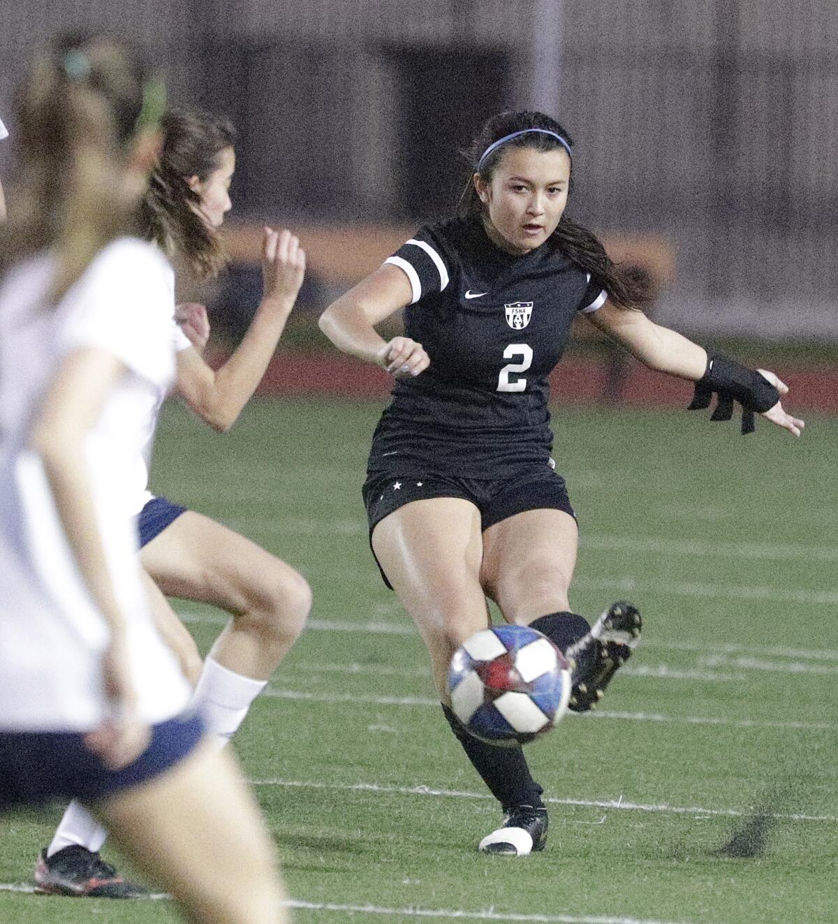 Flintridge Sacred Heart's Madeleine Hara clears the ball just as Sherman Oaks Notre Dame's Maya Naor gets to her in a Mission League girls' soccer game at Occidental College in Los Angeles on Wednesday, January 8, 2020.