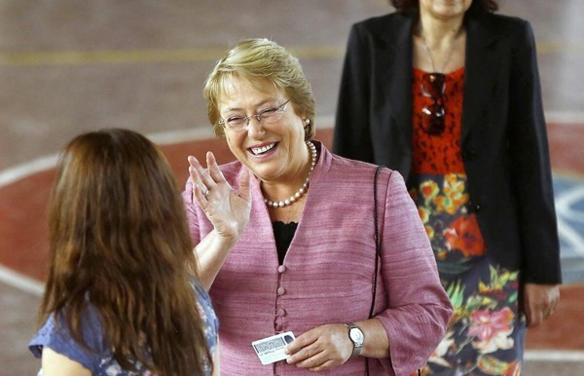 Chilean presidential candidate Michelle Bachelet waves before casting her vote in Santiago.