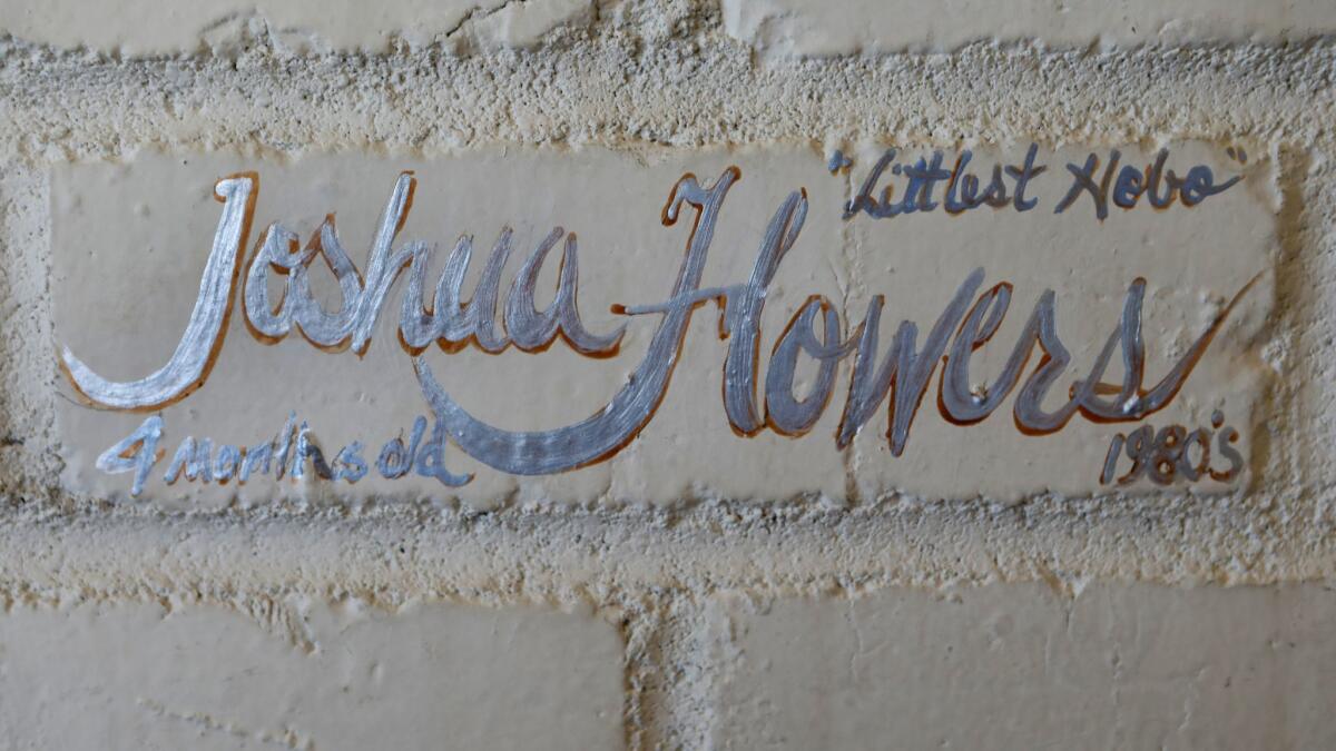 The names of homeless people who have died on the streets of Santa Barbara are painted on a memorial wall in Chuck Blitz's home.