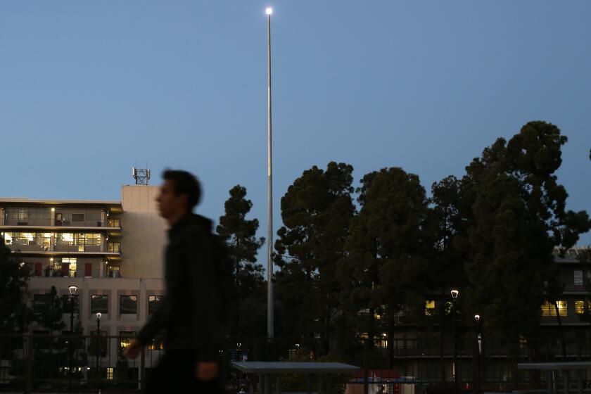 Los Angeles artist Mark Bradford created a195-foot pole topped with a blinking lamp that transmits in Morse code the first message ever sent by telegraph. "WHAT HATH GOD WROUGHT" stands on the campus of UC San Diego, shown here on Dec. 4, 2018. (Photo by K.C. Alfred/San Diego Union-Tribune)