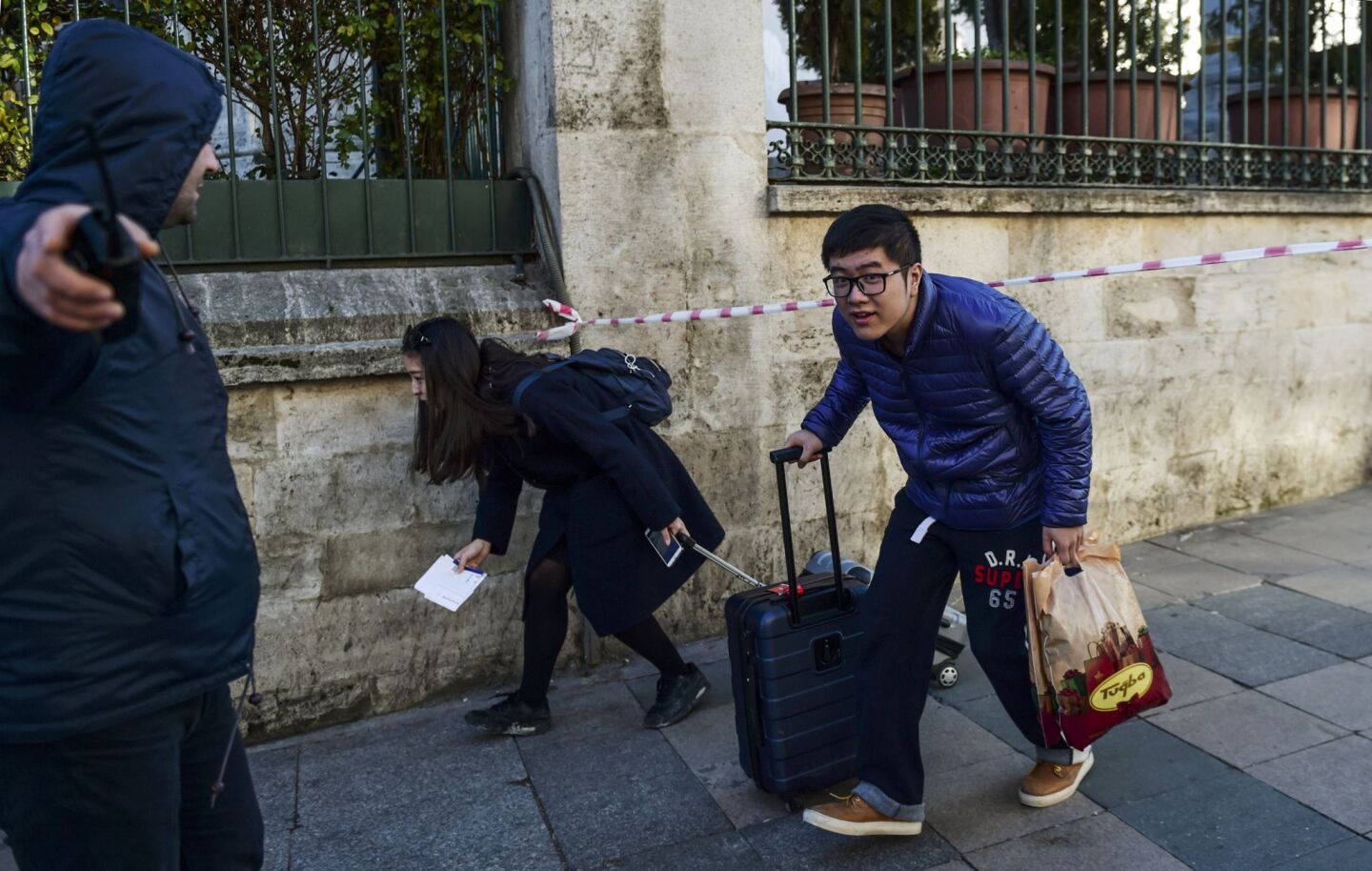 Tourists leave the area near the site of a blast in Istanbul's tourist hub of Sultanahmet.