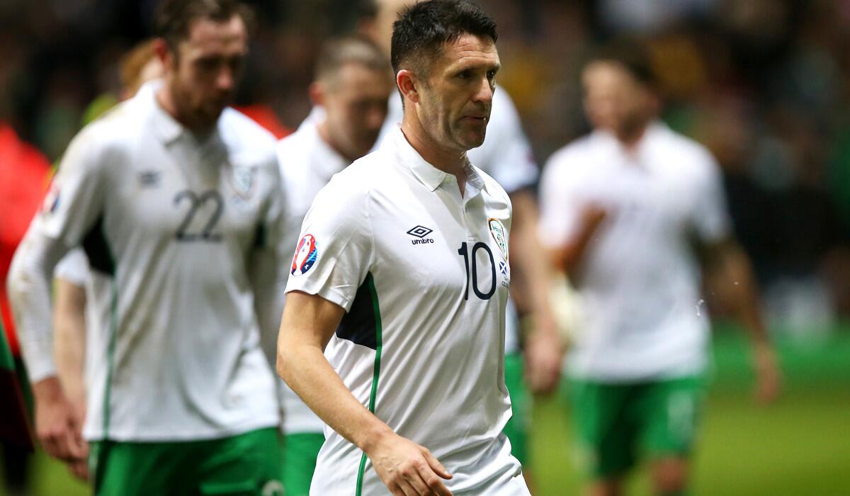 Galaxy star Robbie Keane leaves the pitch with his Ireland teammates after a 1-0 loss to Scotland in a European Championship qualifier on Friday in Glasgow.