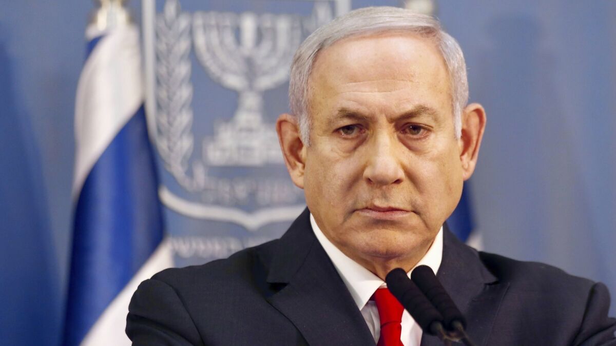 Israeli Prime Minister Benjamin Netanyahu delivers a statement in Tel Aviv on Nov. 18, 2018. Netanyahu says he will take over temporarily as defense minister as early elections still loom.