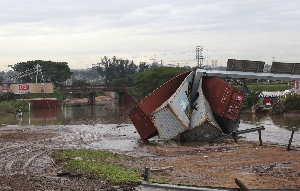 Shipping containers carried away and left in a jumbled pile by floods in Durban.