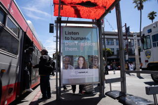 A bus stop advertises Outset, an AI software company, in the Mission District in San Francisco.