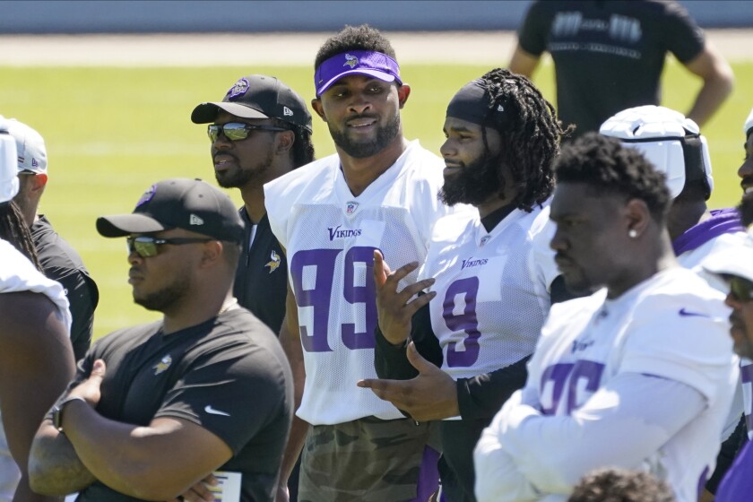 Minnesota Vikings defensive end Danielle Hunter (99) and defensive tackle Sheldon Richardson (9) chat during NFL football minicamp practice Tuesday, June 15, 2021, in Eagan, Minn. Hunter just signed a re-worked contract. (AP Photo/Jim Mone)