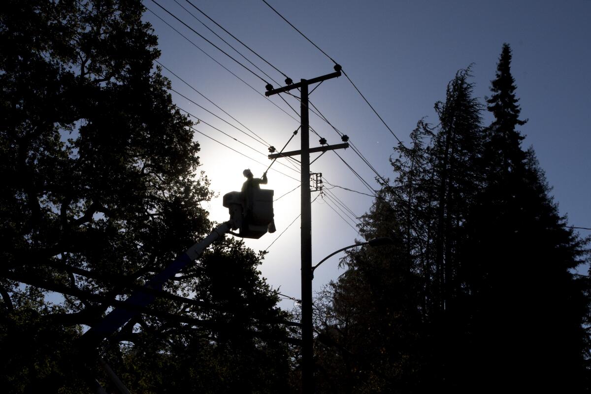 A PG&E line inspector works to clear lines in Northern California. 