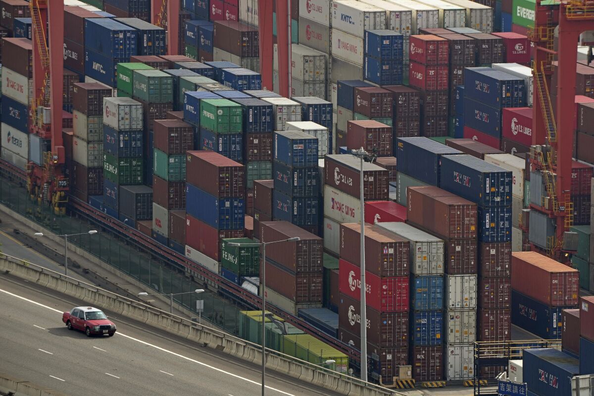 FILE - Shipping containers are seen at a port of Kwai Tsing Container Terminals in Hong Kong, Friday, Nov. 5, 2021. The United States has accused China in a report Wednesday, Feb. 16, 2022, of failing to meet its commitments to the World Trade Organization. (AP Photo/Kin Cheung, File)