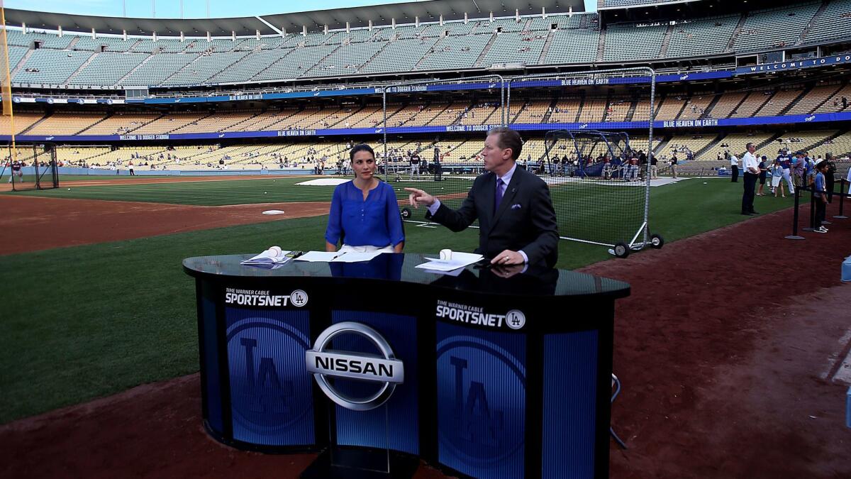 Time Warner Sportsnet Dodgers commentators Alanna Rizzo, left, and Orel Hershiser, do a pregame show before the Dodgers face the Atlanta Braves.