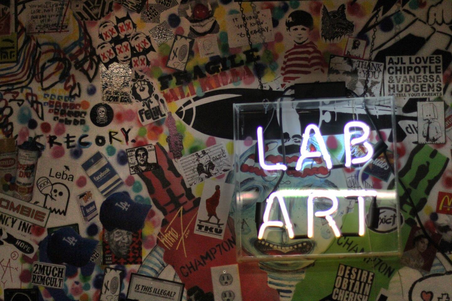 Fluorescent light sign in bar at Lab Art, which features street artists.