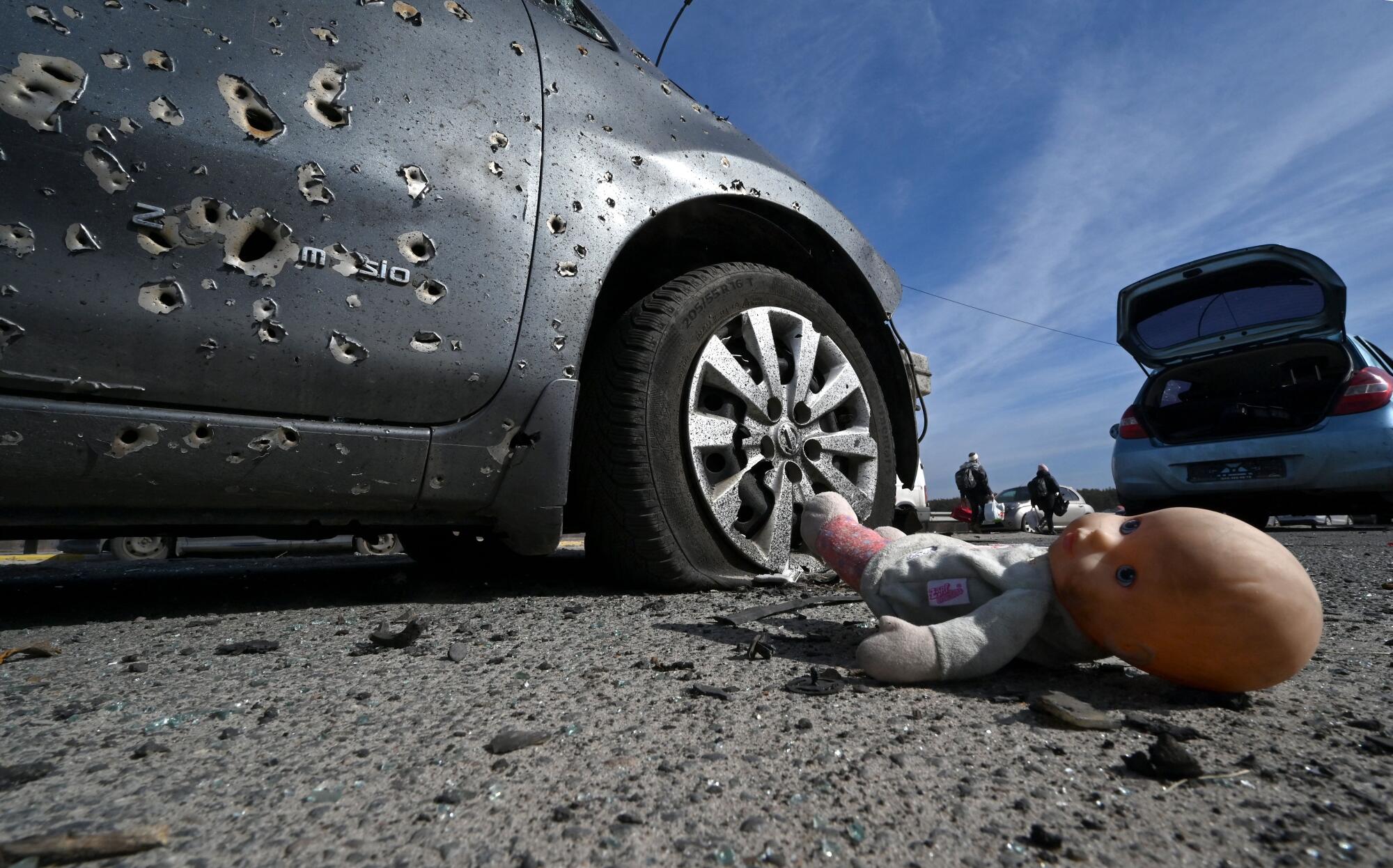 A doll next to a car riddled with bullets in Irpin, north of Kyiv. 