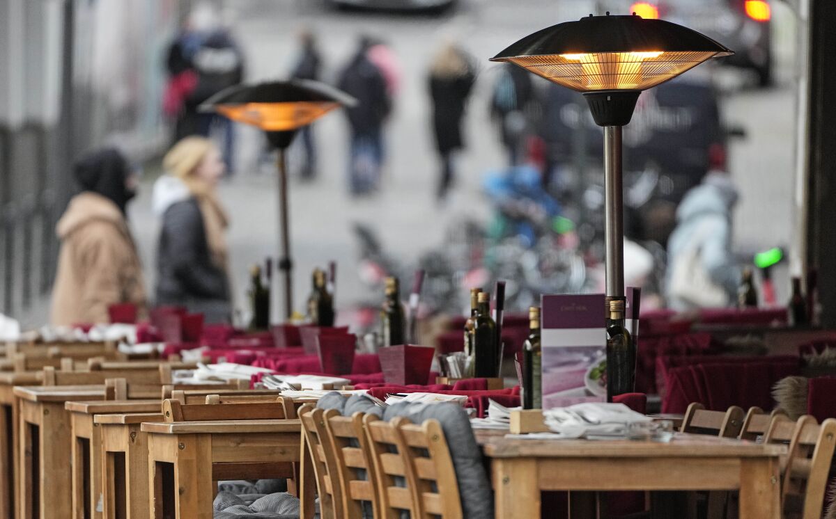 An empty restaurant waits for customers in Cologne, Germany, Friday, Jan. 7, 2022. New corona measures are expected from a meeting of German governors and the federal government today to fight the COVID-19 pandemic. (AP Photo/Martin Meissner)