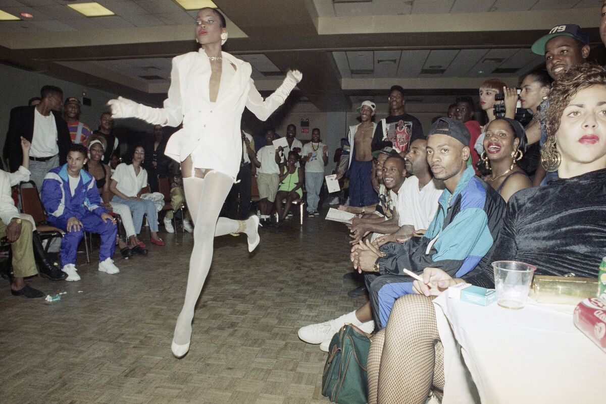 One person voguing in front of a crowd