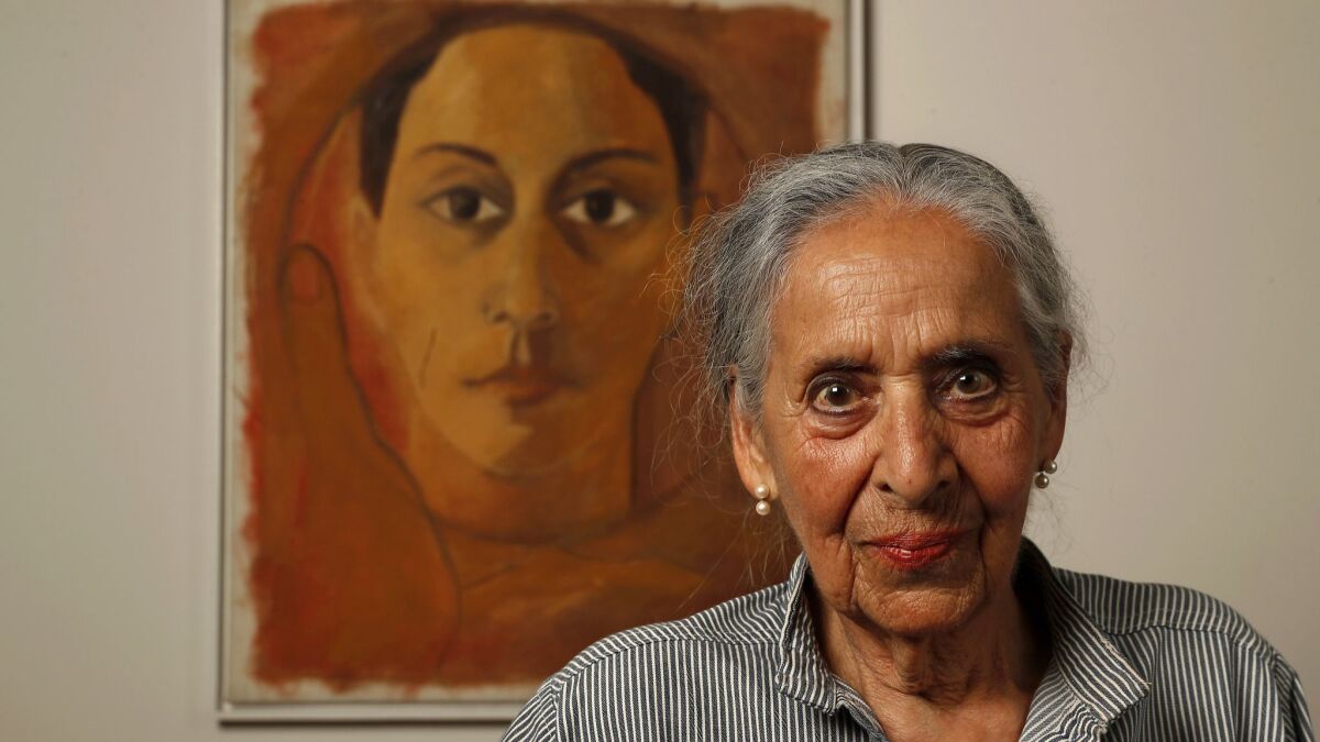 Luchita Hurtado, 97, stands before a self-portrait painted in the 1950s.