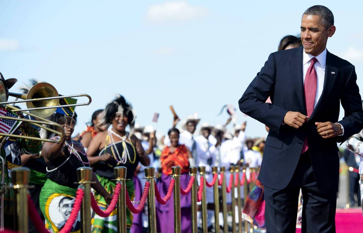 President Obama dances to music on arrival at the airport in Dar es Salaam, Tanzania. Tanzanians gave Obama his biggest reception yet on the final leg of his three-nation African tour.