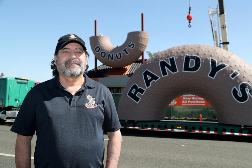 Newport Beach resident Mark Kelegian, a lawyer and entrepreneur, purchased the Randy's Donuts brand in 2015 stands in front of his new Costa Mesa location.