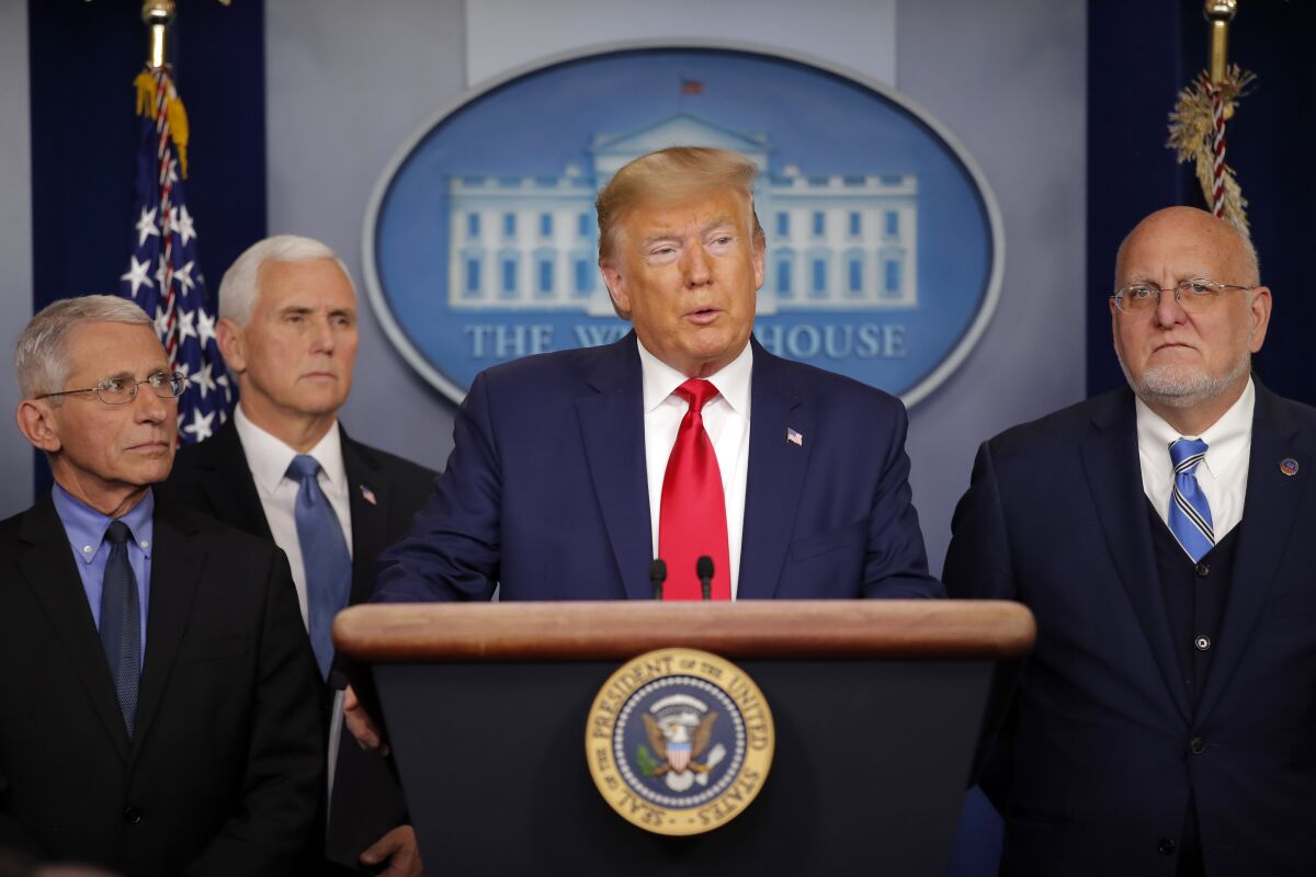 President Trump speaks about the coronavirus on Saturday and is flanked by National Institute for Allergy and Infectious Diseases director Anthony Fauci, Vice President Mike Pence and Robert Redfield, director of the Centers for Disease Control and Prevention.