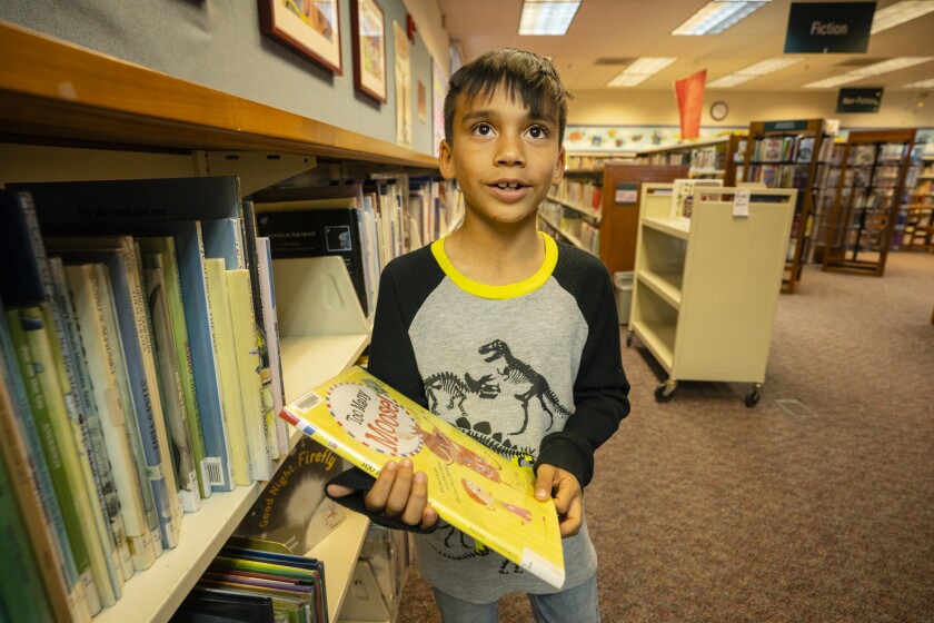 Nicolas Maldonado, 7, chooses a book at the Clara M. Jackson branch of the Kern County Library in McFarland. 