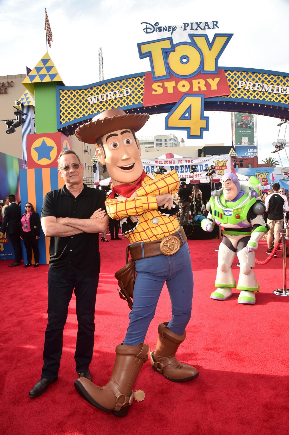 Tom Hanks poses with Woody at the premiere of "Toy Story 4"