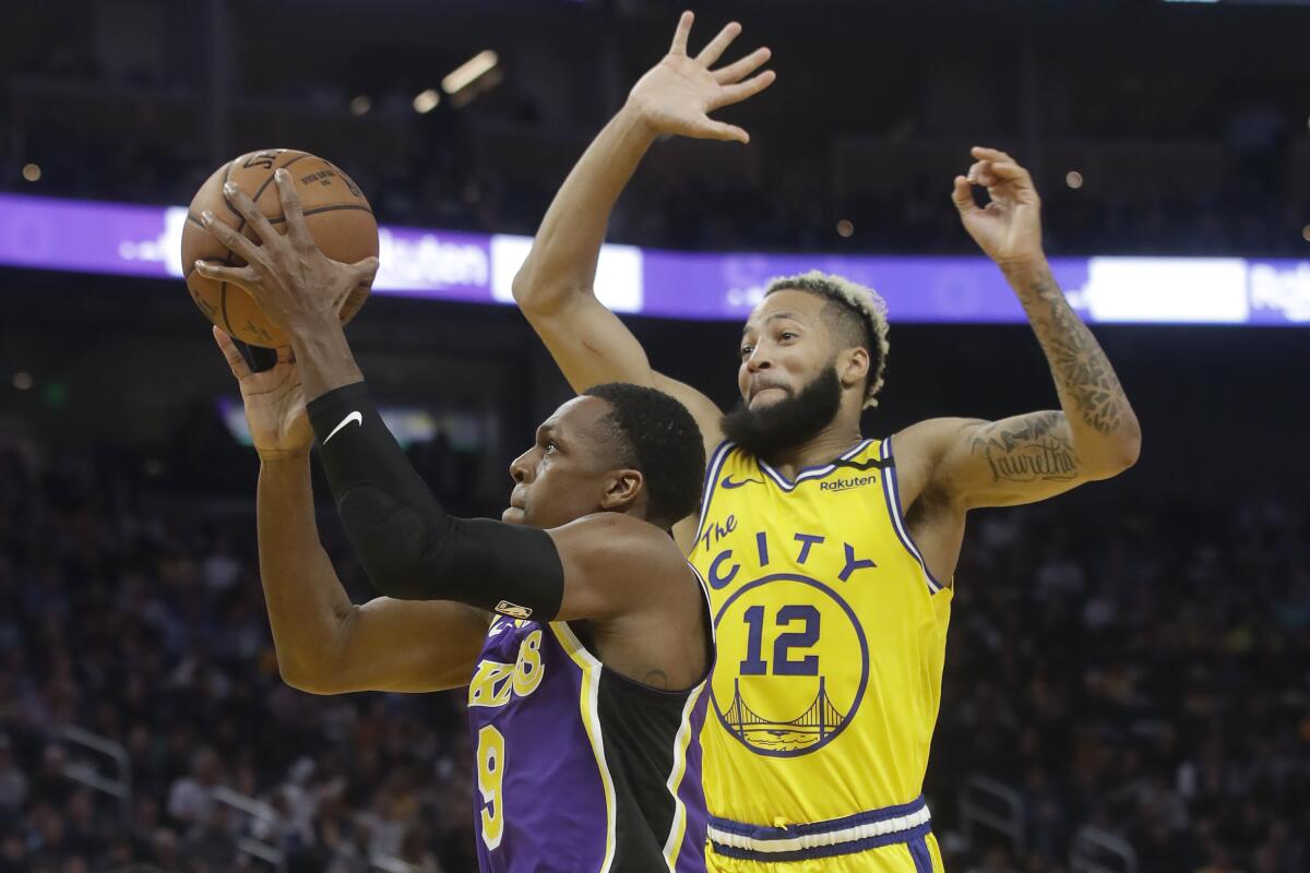 Lakers guard Rajon Rondo (9) shoots against Golden State Warriors guard Ky Bowman (12) during the first half on Thursday in San Francisco.