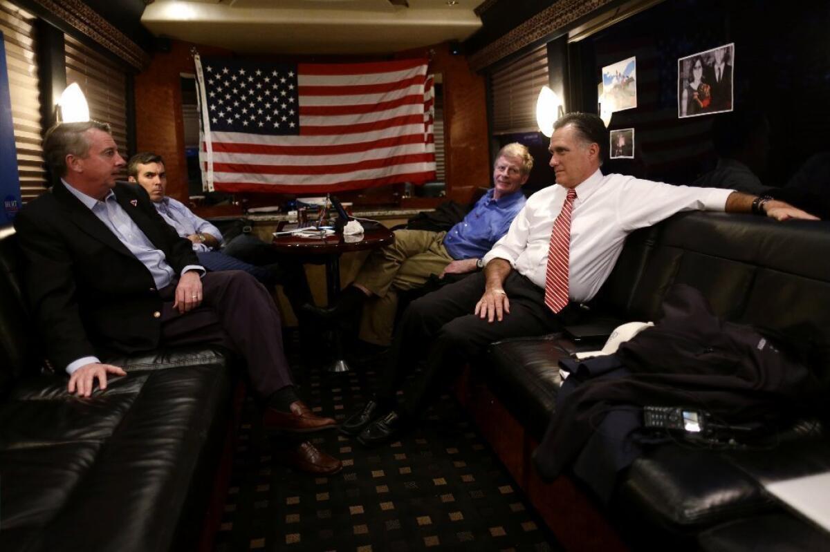 Republican Mitt Romney meets with advisors Ed Gillespie (from left), Kevin Madden and Stuart Stevens on his campaign bus.