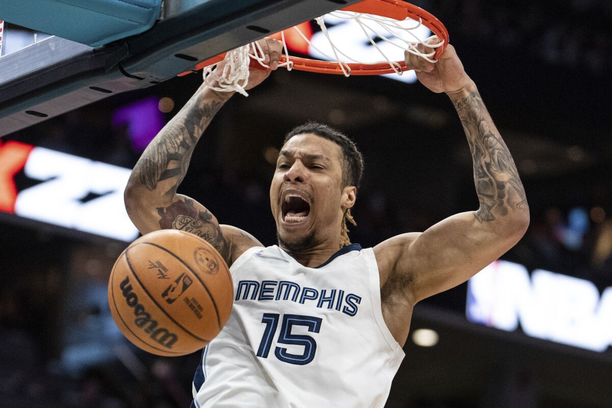 Memphis Grizzlies forward Brandon Clarke dunks the ball against the Charlotte Hornets during the first half of an NBA basketball game in Charlotte, N.C., Saturday, Feb. 12, 2022. (AP Photo/Jacob Kupferman)