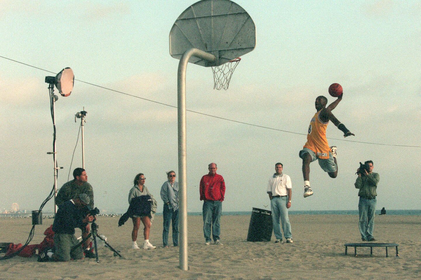An airborne Kobe Bryant goes for a dunk while shooting a commercial.